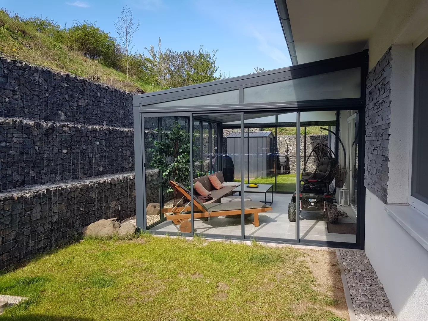 Nowoczesna pergola aluminiowa ze szklanym zadaszeniem i systemem przesuwnym przy domu w Braňanach.